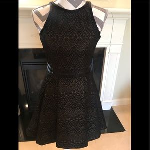 Parker black cocktail dress with mesh cut outs.